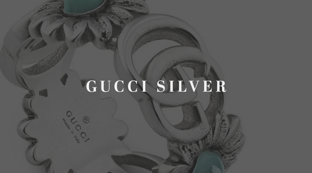 A close up of a Gucci ring with text gucci silver