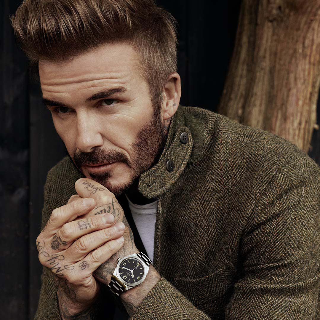 David Beckham brown jacket wood background